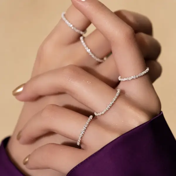 Sterling silver stackable rings worn together on the hand showing layered stack.