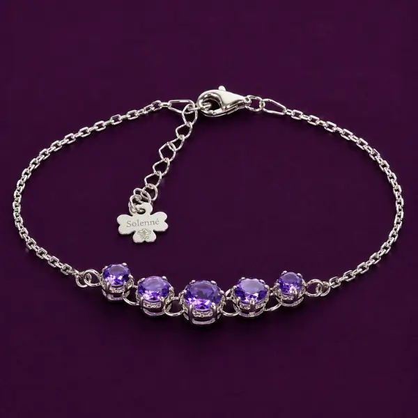 Silver amethyst bracelet with faceted stones on Solenne plum background
