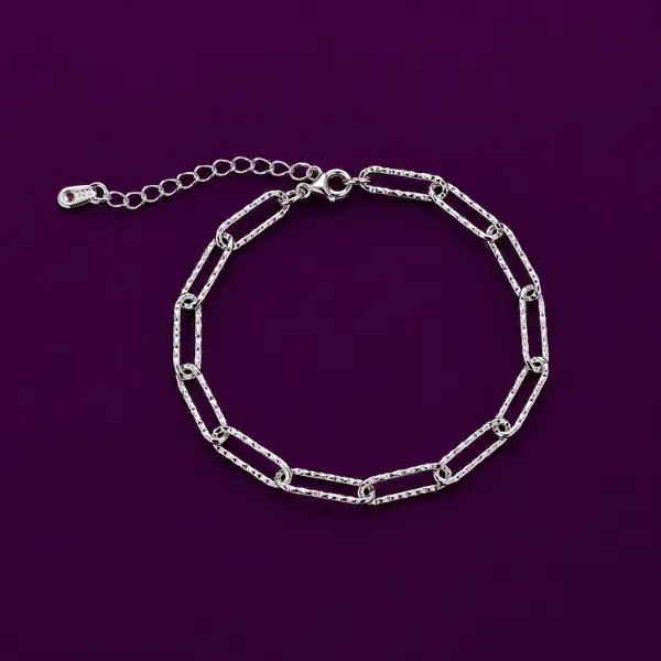 Silver paperclip bracelet, paper clip chain link design laid flat